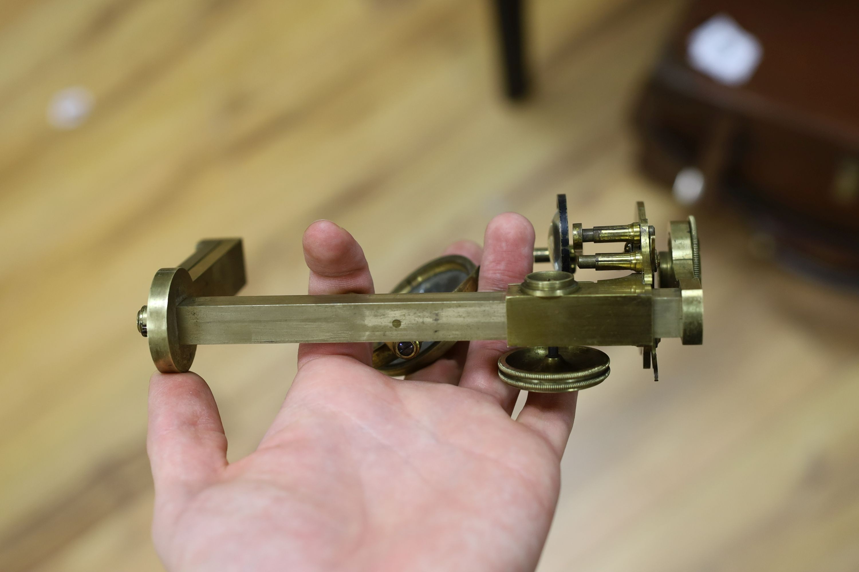 A mahogany cased microscope and a pair of Burdizzo tail dockers, 40cms long
